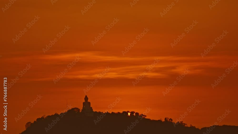 Time Lapse The sun circles behind the Buddha on the mountain as the sun travels from the sky and falls behind the mountain. .The Sky gradually changed color from yellow to orange and red over time... Time Lapse The sun circles behind the Buddha on the mountain as the sun travels from the sky and falls behind the mountain. .The Sky gradually changed color from yellow to orange and red over time...