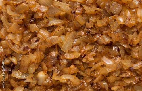 Caramelized onion pieces texture background top view