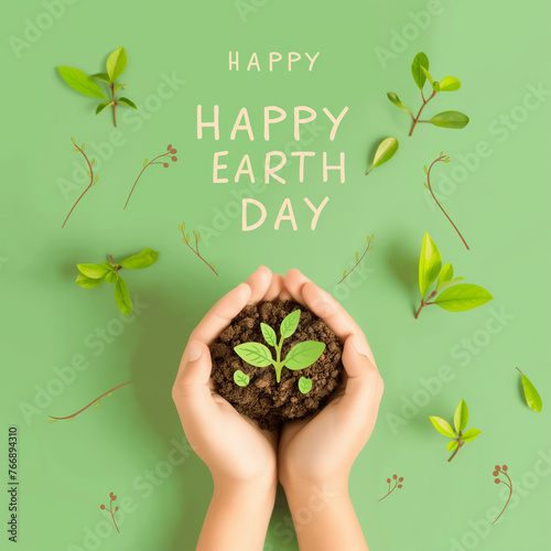 Happy Earth Day with young hands holding soil and a plant on a green background