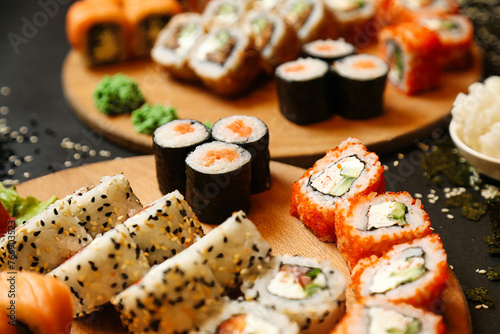 Assorted Sushi on Wooden Plates on Table