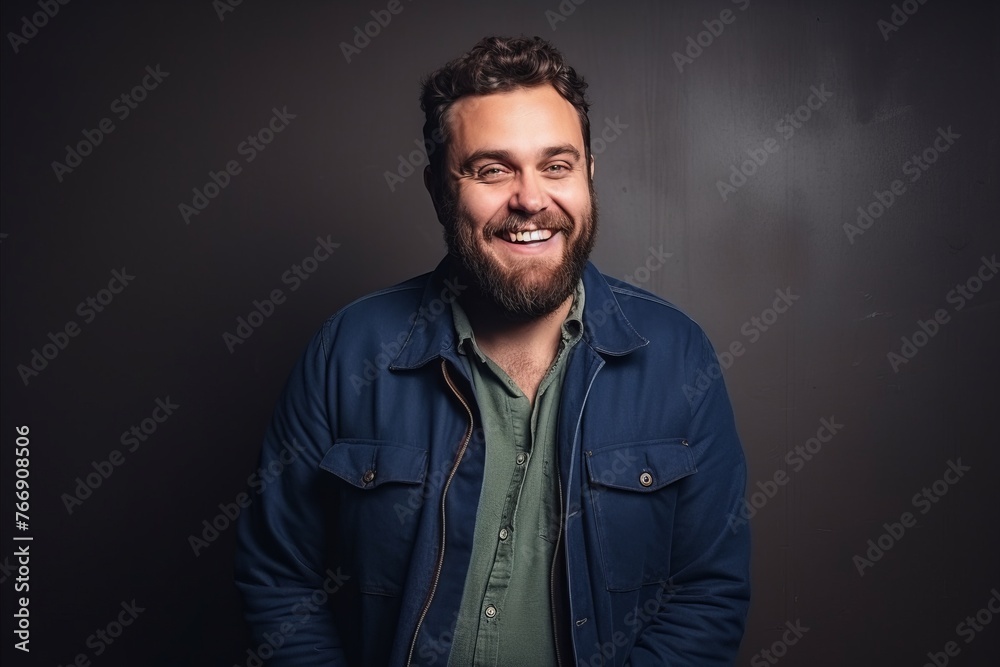 Portrait of a handsome man smiling at the camera over black background. Portrait of a handsome man smiling at the camera over black background.