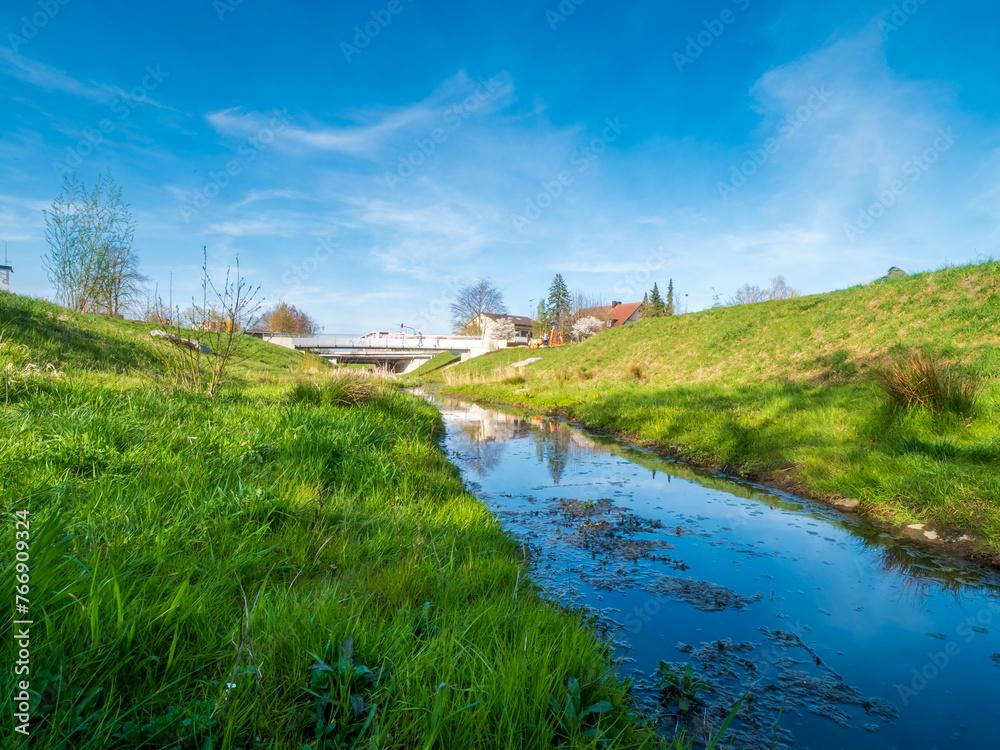 Fototapeta premium Pfaffenhofen Bürger Park with the Ilm as a little creek and blue sky background