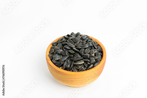 black sunflower seeds in a small wooden cup