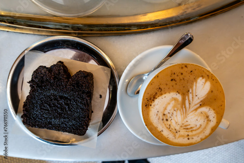 Istanbul, Turkey A chocolate cake and a cappucino foffe on a countertop in a cafe. photo