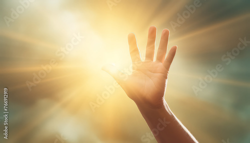 A hand is raised in the air with the fingers spread out