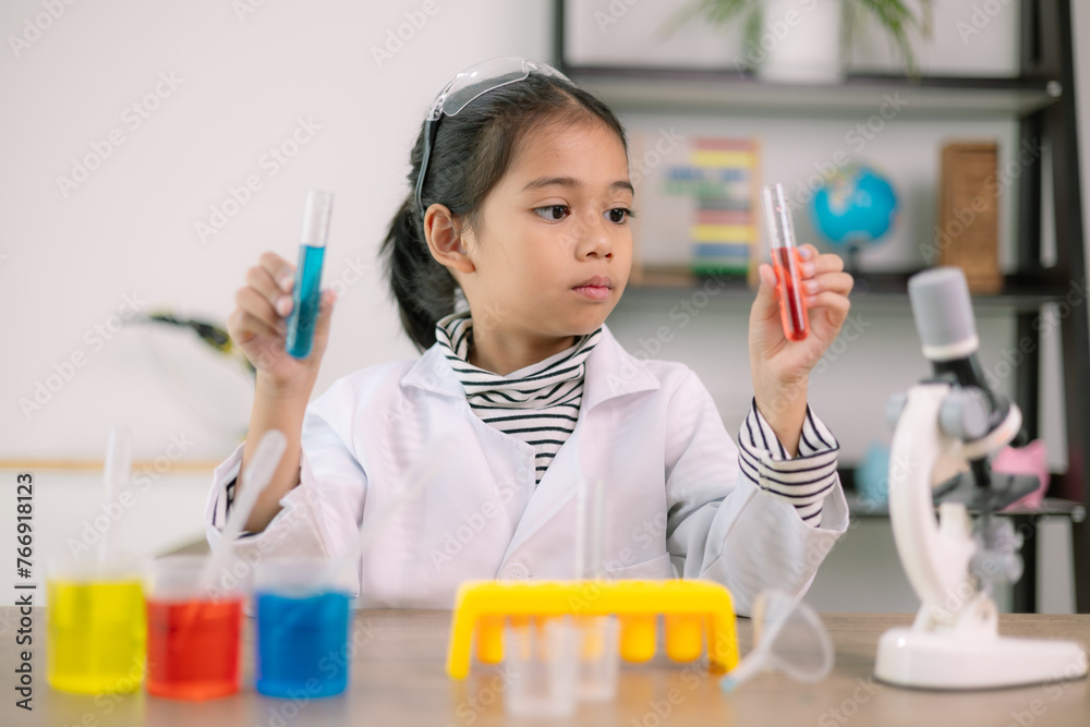 Asian child girl learning science chemistry with test tube making experiment at school laboratory. education, science, chemistry, and children's concepts. Early development of children. Asian child girl learning science chemistry with test tube making experiment at school laboratory. education, science, chemistry, and children's concepts. Early development of children.
