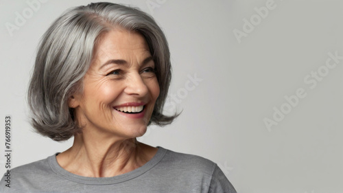 Natural beautiful happy middle aged woman with grey bob hairstyle. 