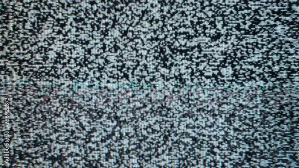 Close-up view of static noise on an old television screen. The static consists