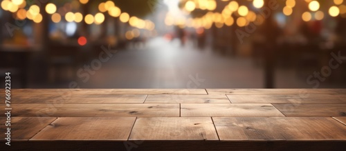 A hardwood table stands in the foreground with a blurred background featuring a mix of buildings and road surfaces. The wood is stained with a rich shade, adding character to the room