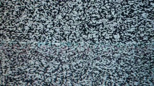 Close-up view of static noise on an old television screen. The static consists photo
