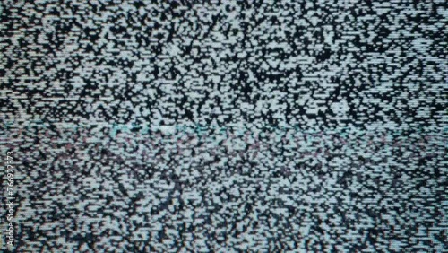 Close-up view of static noise on an old television screen. The static consists