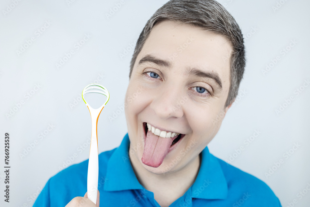 Tongue scraper. Man shows yellow plaque and then performs oral hygiene. Cleaning the tongue with special tool. Doctor recommendations and dentist advice. Before and after. Removing unpleasant odor Tongue scraper. Man shows yellow plaque and then performs oral hygiene. Cleaning the tongue with special tool. Doctor recommendations and dentist advice. Before and after. Removing unpleasant odor