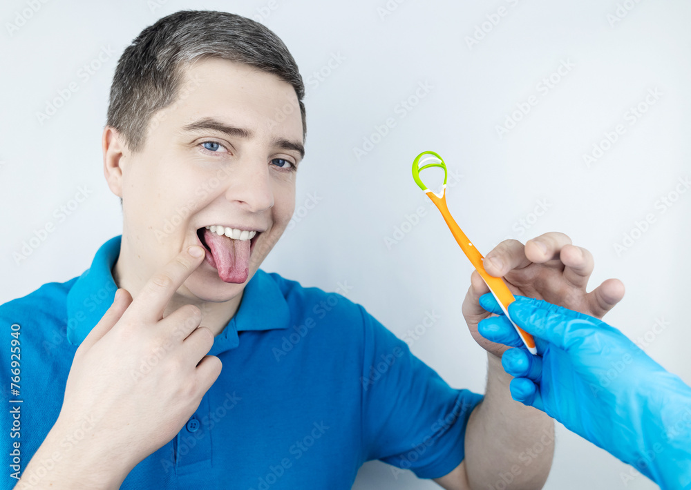 tongue-scraper-man-shows-yellow-plaque-and-then-performs-oral-hygiene