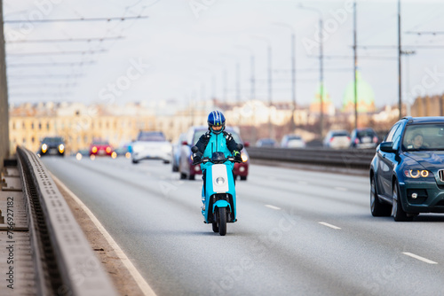Blue electric scooter driving on the highway