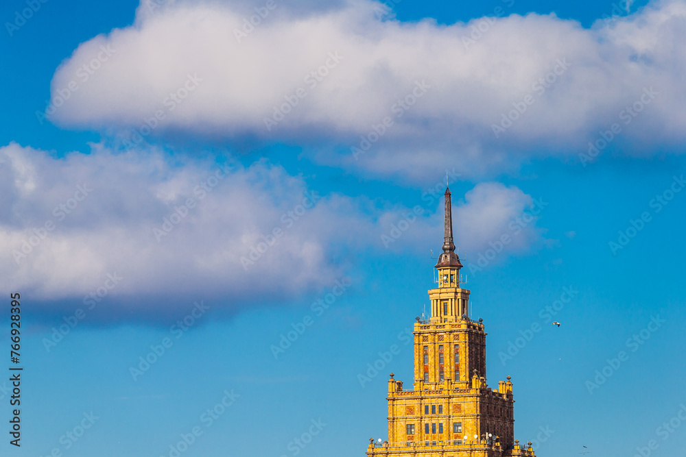 Sunny day and big clouds with big building top almost scraping the blue sky Sunny day and big clouds with big building top almost scraping the blue sky