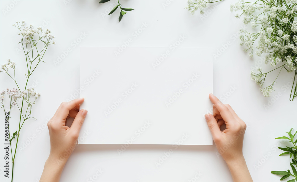 Hands are holding a blank sheet of paper with a white background. Hands are holding a blank sheet of paper with a white background.