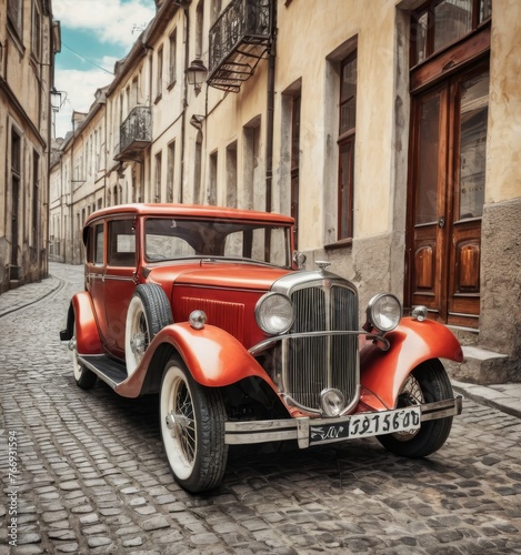 A classic red and black vintage car parked on a cobblestone street evokes a sense of the early automotive era. The vehicle's immaculate condition and historic architecture surrounding it transport the © Anastasiia