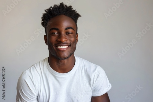 A smiling black man with a white shirt
