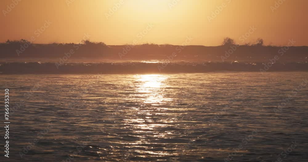 Ocean waves at sunset close-up Water. Close-up detail of an ocean wave vertical crashing hollow wave-forming water at sunset. energetic force of nature. Ocean waves at sunset close-up Water. Close-up detail of an ocean wave vertical crashing hollow wave-forming water at sunset. energetic force of nature.