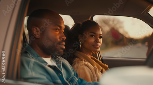beautiful south african woman and a handsome black man driving in a car photo