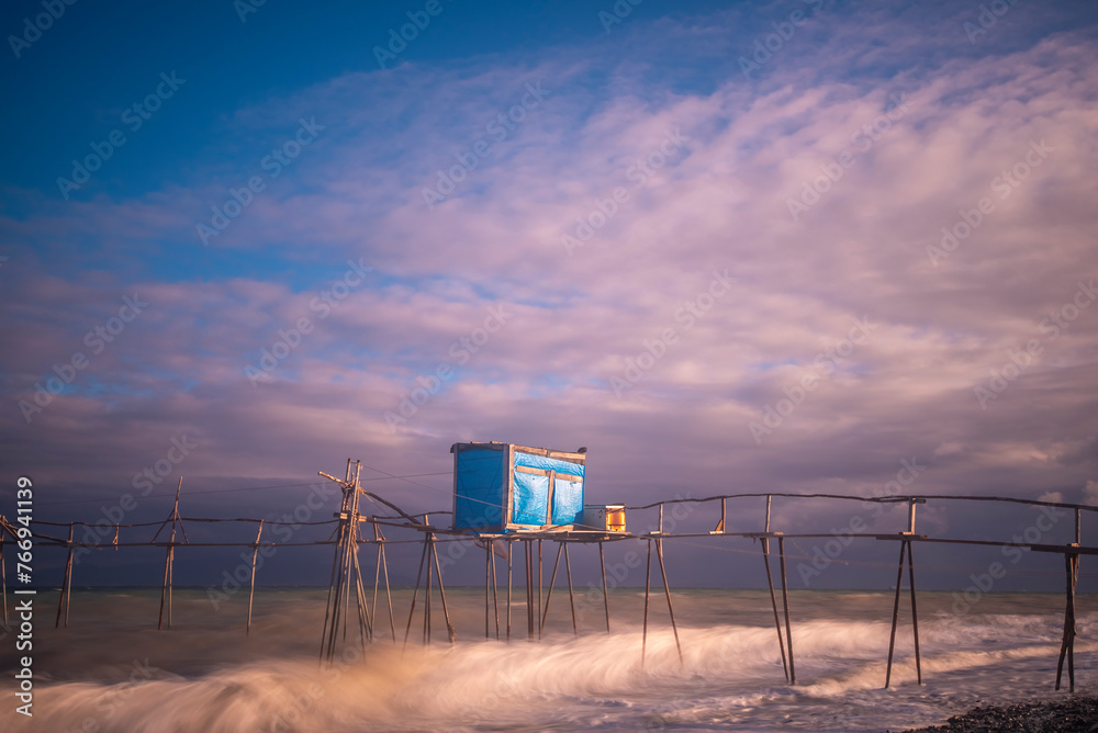 wooden fishing piers lying on the sea of Marmara cloudy weather sunset hours while the waves hit the beach wooden fishing piers lying on the sea of Marmara cloudy weather sunset hours while the waves hit the beach