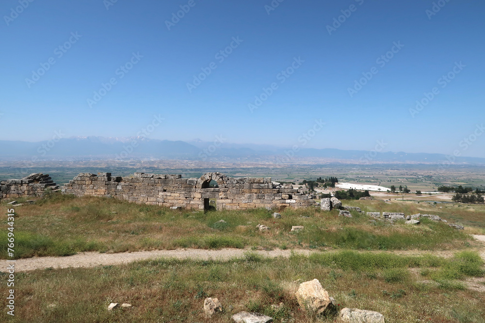 The town wall of the ancient site of Hierapolis with Pamukkale, the valley and the mountains in the background, Denizli, Turkey