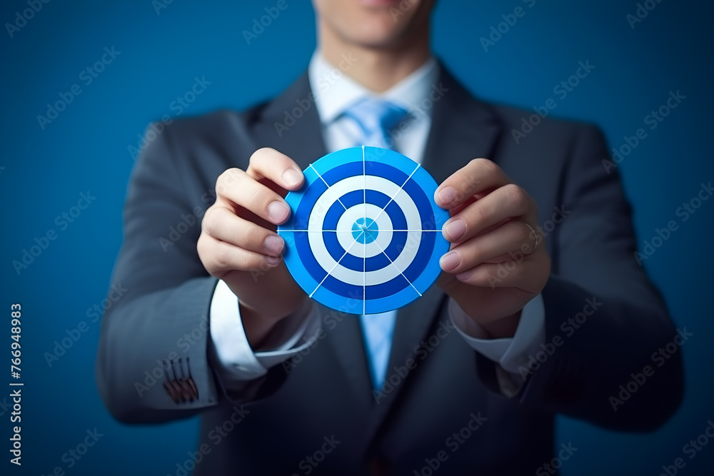 businessman holding a big dart board,dart target,circle target,business goal concept,blue background businessman holding a big dart board,dart target,circle target,business goal concept,blue background