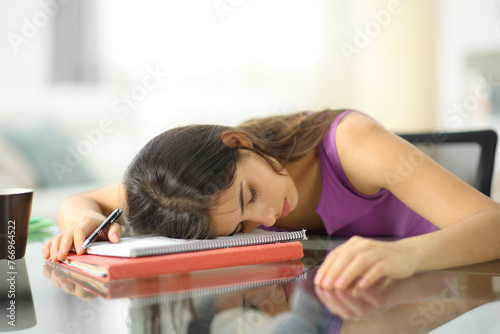 Tired overworked student sleeping at home