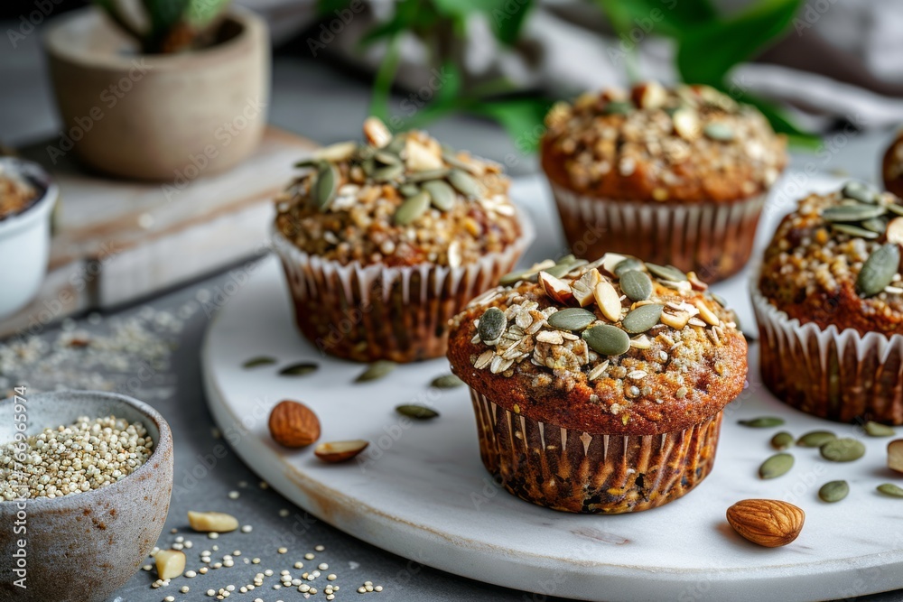 Vegan muffins with a nutritious quinoa and seed topping on a marble surface