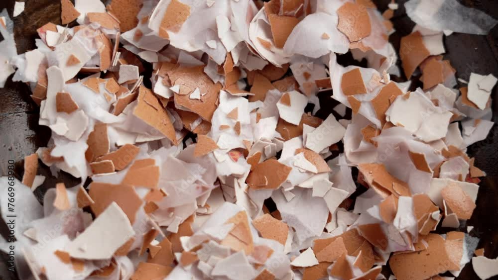 Pile of broken eggshells in wooden dish. Crushed shell. Calcium nutrient source. Organic compost Ingredient. Rotation