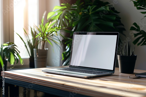 An ideal workspace setup, featuring a laptop with a blank screen for mockups, positioned on a wooden desk