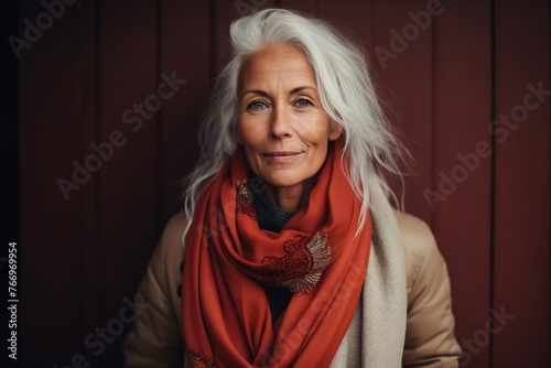 Portrait of a beautiful senior woman with white hair and red scarf.