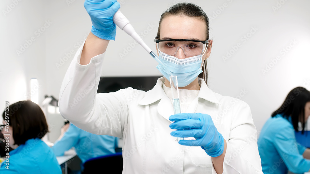 A scientist in a modern laboratory studies samples and conducts experiments. Microbiology, pharmaceutical biochemistry, medical technology. Working on vaccines and medicines in a team of specialists.
