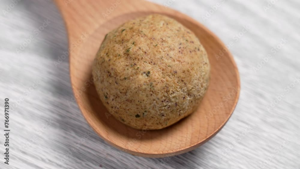 Fresh baked hot homemade bun in wooden spoon on a kitchen board. Easter bread. Rotation Fresh baked hot homemade bun in wooden spoon on a kitchen board. Easter bread. Rotation