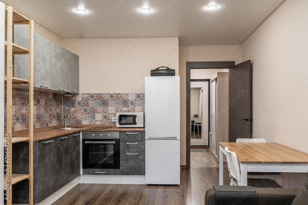 large modern grey kitchen with wooden furniture and appliances large modern grey kitchen with wooden furniture and appliances