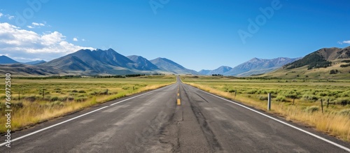 Empty asphalt road on grassland