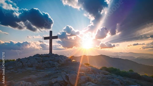 Christian cross in the glow of the sun, mountain landscape above the clouds