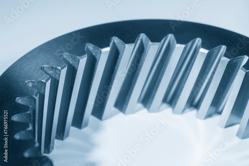 Close up scene the inner helical  gear parts spare parts in the light blue scene.