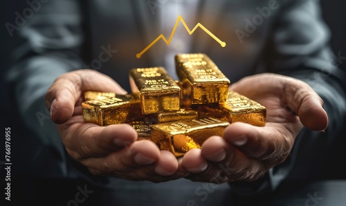 Businessman's hands hold gold bars against the background of an upward arrow of the gold price