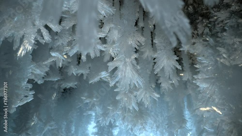 Beautiful crystal icicles, ice snowflakes on stalactites inside frozen cave  photo