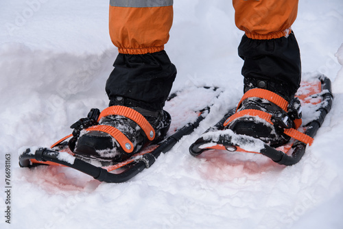 man walking on trail in snowshoes