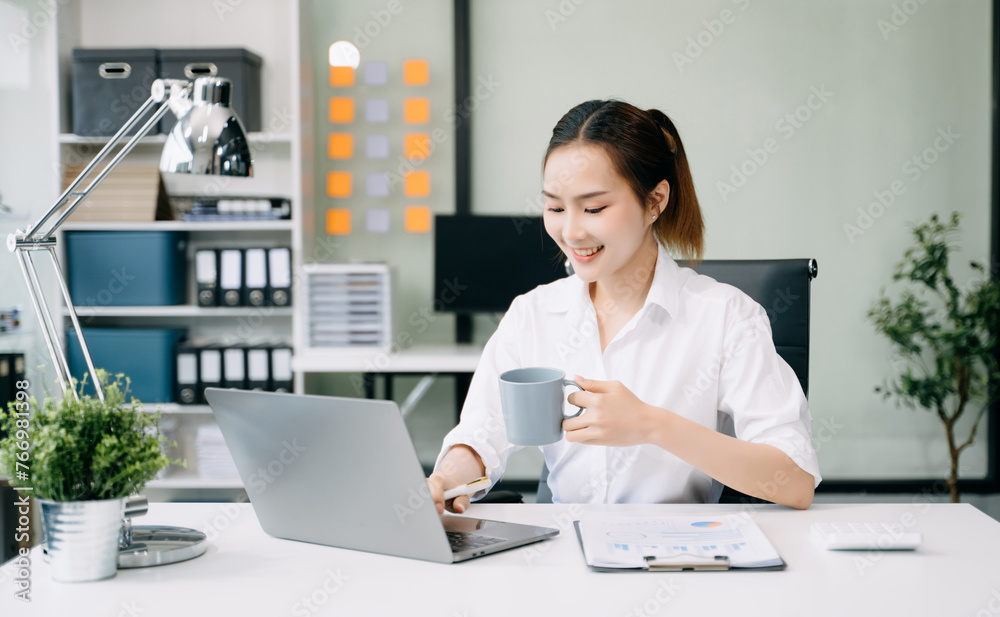 Asian Businesswoman Analyzing Finance on Tablet and Laptop at Office Desk tax, report, accounting, statistics, and analytical research concept Asian Businesswoman Analyzing Finance on Tablet and Laptop at Office Desk tax, report, accounting, statistics, and analytical research concept