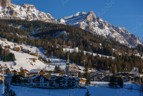 Idyllic dolomite village during winter with snow covered mountains in Alta Badia at nature park Fanes-Sennes-Prags, Abtei, Badia, South Tirol, Italy photo