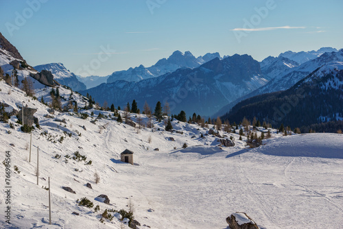 Idyllic view at dolomite mountain landscape during winter with snow covered peaks at pass road of Valparola, South Tirol, Italy photo