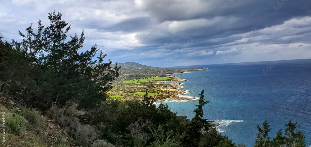 Beautiful blue Mediterranean sea from mountain trail, storm approaching.