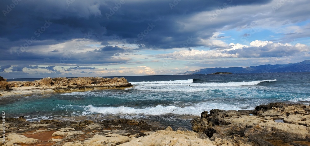 Waves crashing in the Mediterranean sea as storm approaches over the horizon Waves crashing in the Mediterranean sea as storm approaches over the horizon