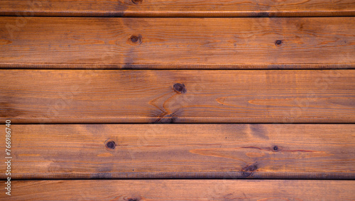 The wooden planks are stacked horizontally and have a worn look.