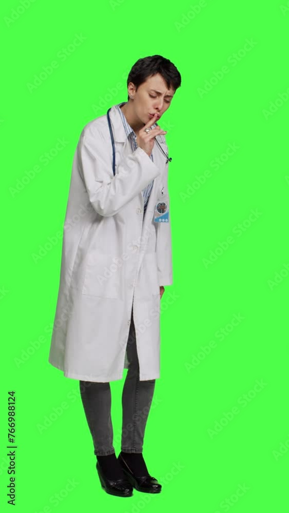 Side view General practitioner showing hush symbol to be quiet and keep secrecy, putting finger over lips for privacy and silence expression. Medic doing mute symbol, asking to be quiet. Camera A.