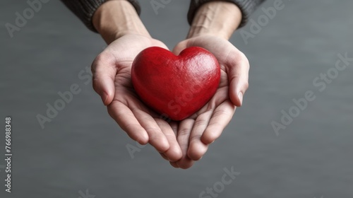 Man holding red heart in hands. Love