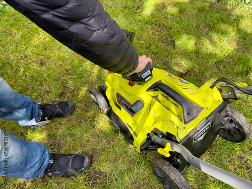 Inserting a Lithium Ion battery on a electric cordless lawnmower